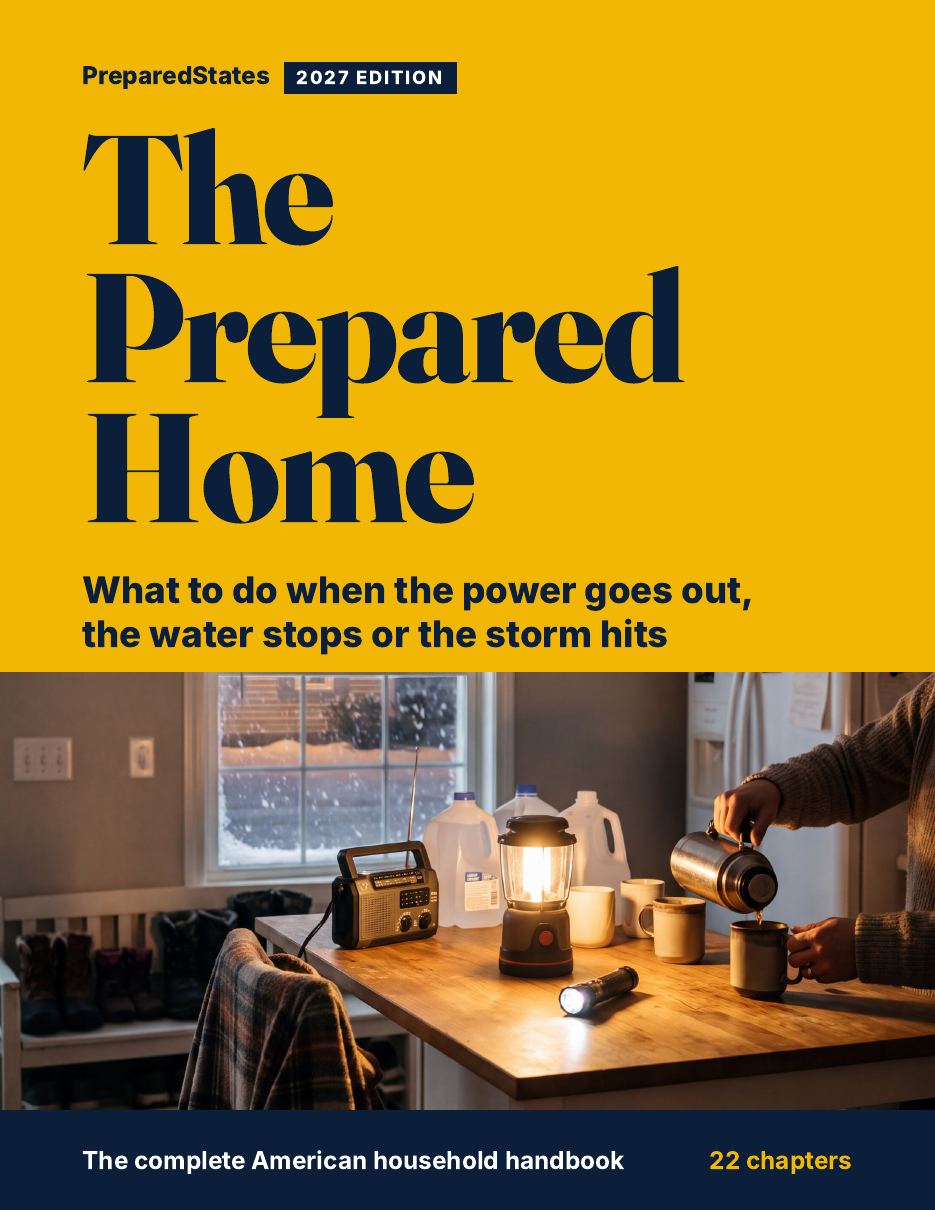 Cover of The Prepared Home, 2027 edition: a lantern, radio and water jugs on a kitchen table in a snowstorm